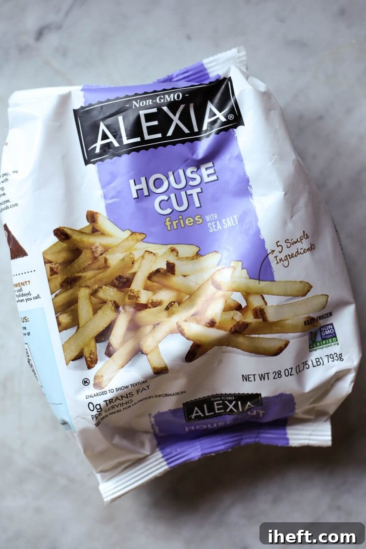 A bag of Alexia house cut frozen french fries on a marble countertop.