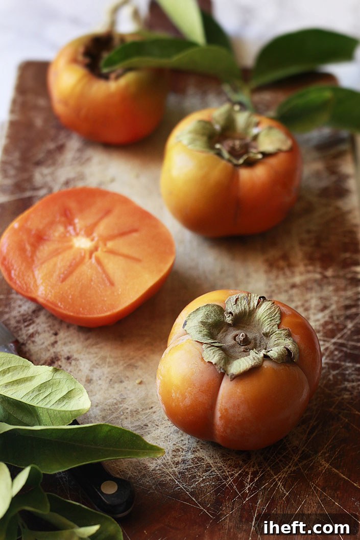 Fuyu persimmons on a cutting board. 