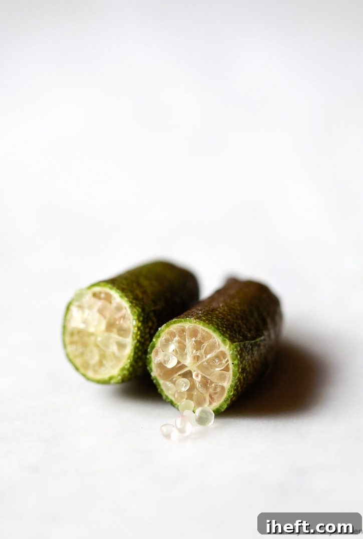 Macro photo of caviar limes, or finger limes, cut in half to show the inside. 