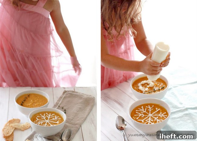 A child's hand decorating a bowl of butternut squash soup with a creme fraiche smiley face.