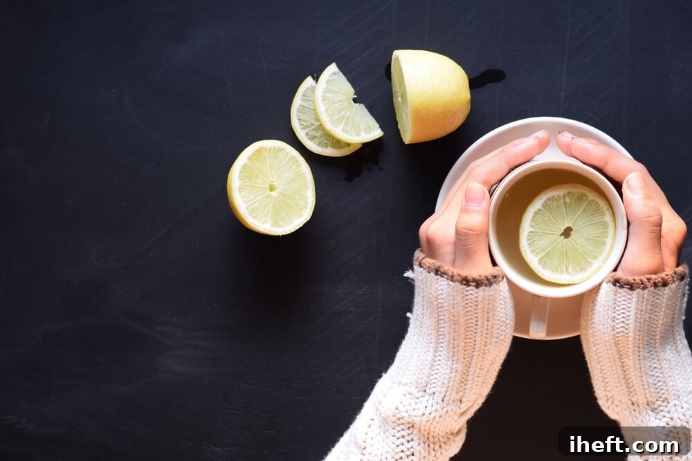 Hands hold a hot mug filled with hot lemon water.