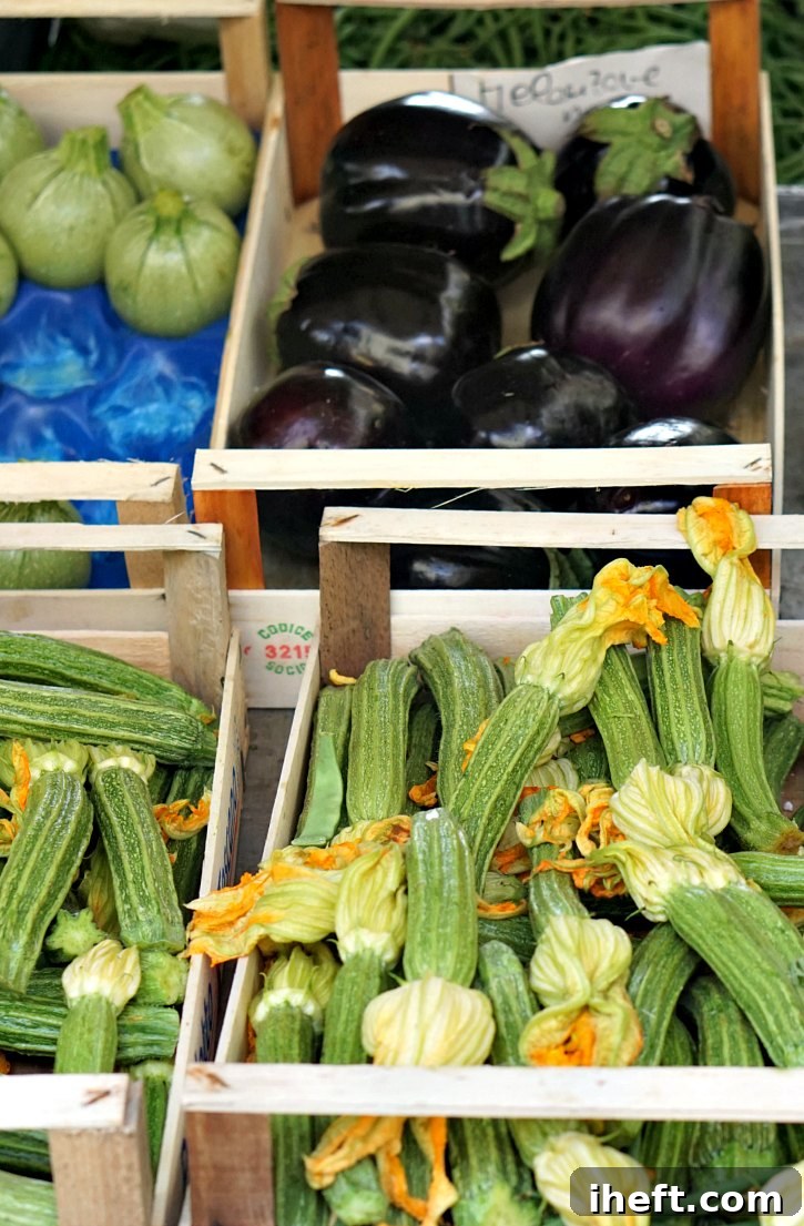 A beautiful photo of zucchini and eggplant at a farmers market in Italy.