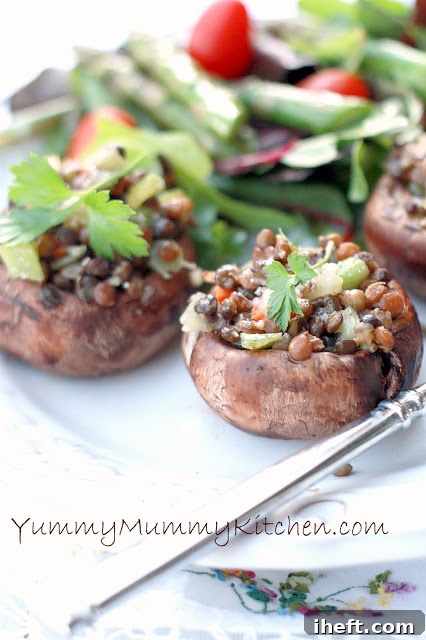 Beautifully prepared jumbo Portobello mushrooms, generously stuffed with a savory lentil and vegetable mixture, ready for a nutritious and delicious meal.
