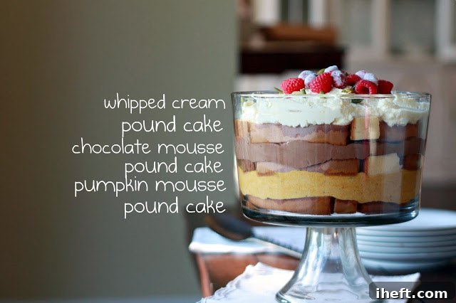 A close-up side view of a decadent Thanksgiving trifle, showcasing distinct and artfully arranged layers of golden pound cake, creamy spiced pumpkin mousse, rich dark chocolate mousse, and a fluffy white whipped cream topping. The trifle is beautifully prepared, ready for final garnishes and serving.
