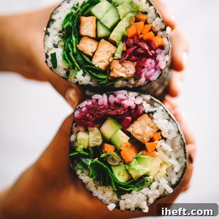 A close-up photo of hands holding a sushi burrito (sushirrito)