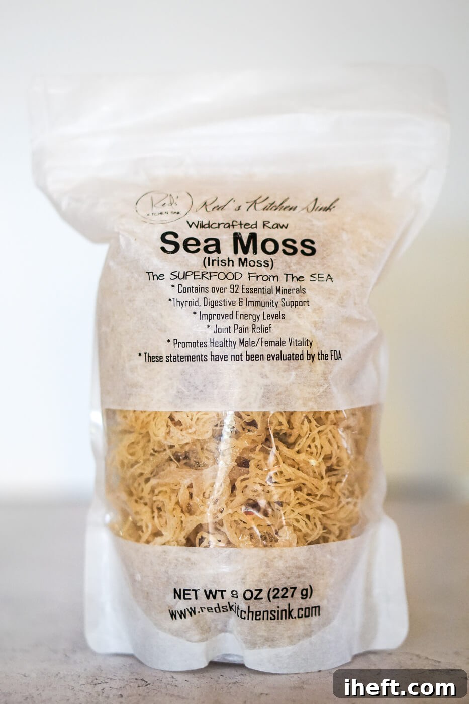 A sealed package of premium dried wildcrafted raw sea moss rests on a clean kitchen countertop, ready for preparation.