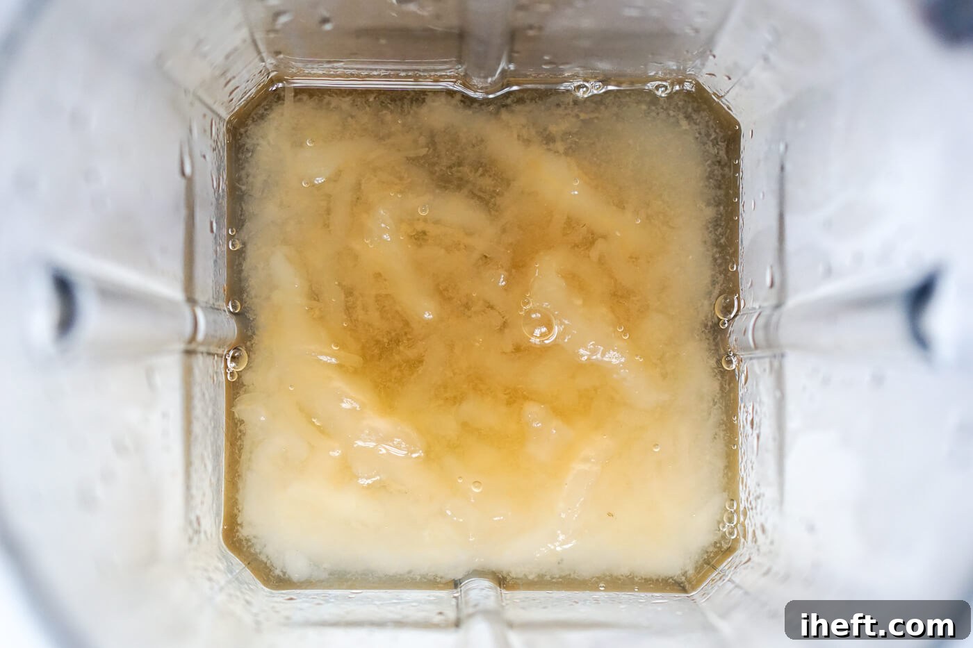 Soaked sea moss and water in the bottom of a blender.
