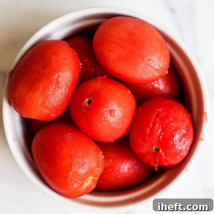 A bowl of peeled Roma tomatoes.