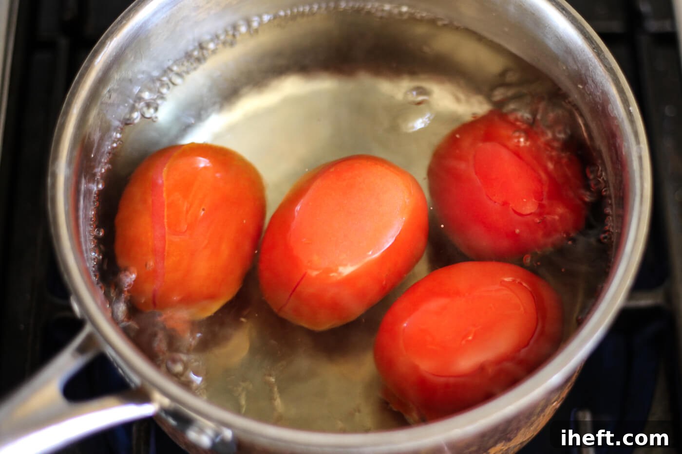 Roma tomatoes in boiling water.