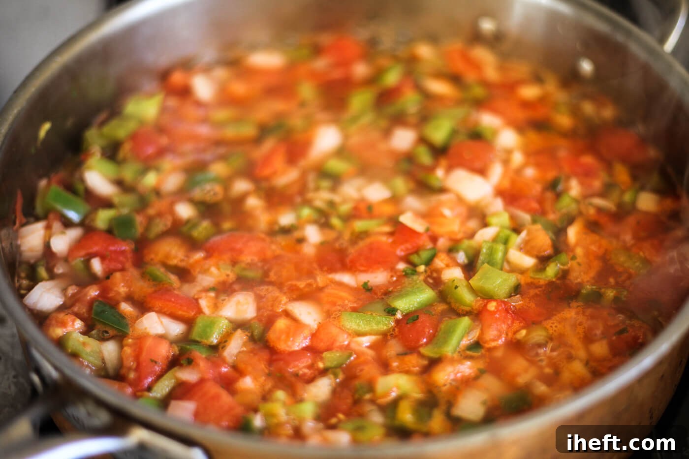 A salsa recipe for canning simmers on the stove.