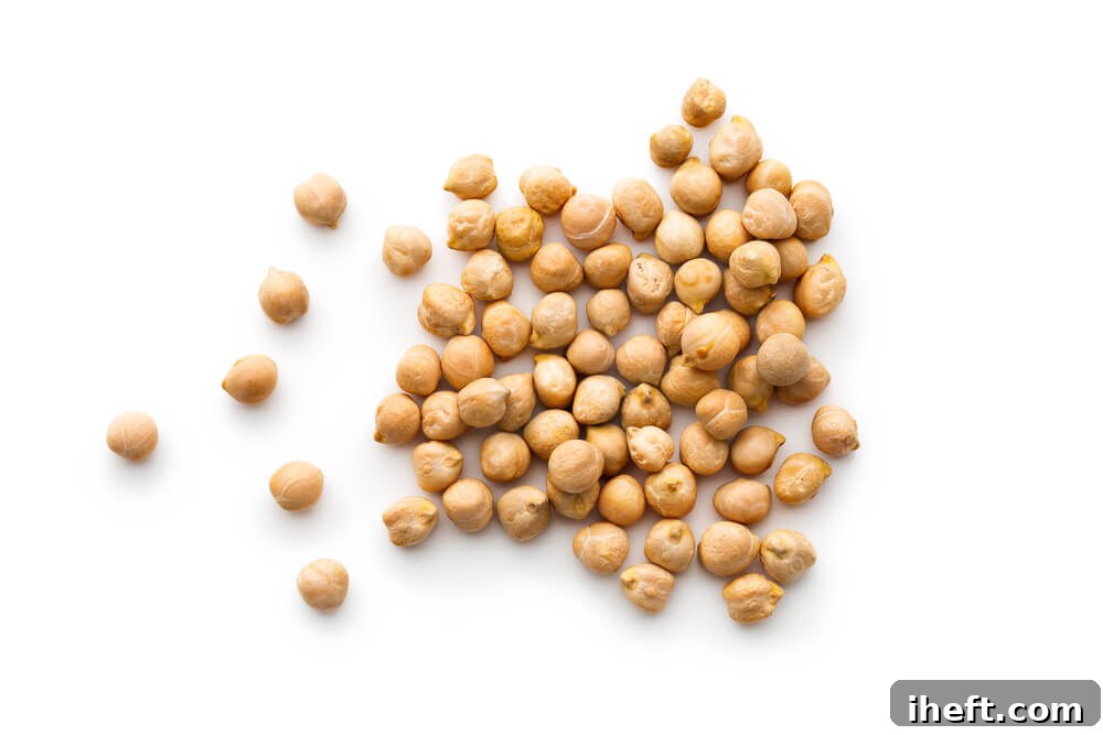 Close up photo of dried chickpeas, highlighting their unique texture.