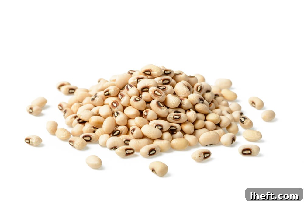 Close-up photo of dried black eyed peas, distinguished by their prominent black spot.