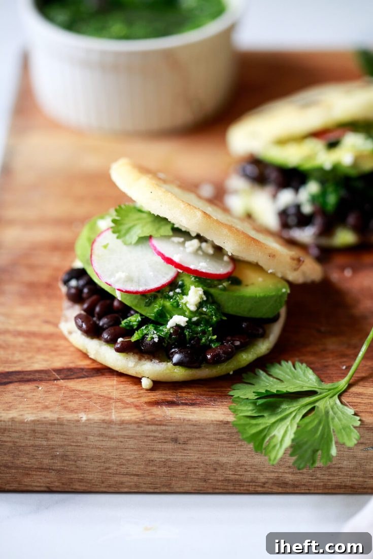 Arepa Venezolana filled with black beans, cheese, and avocado.