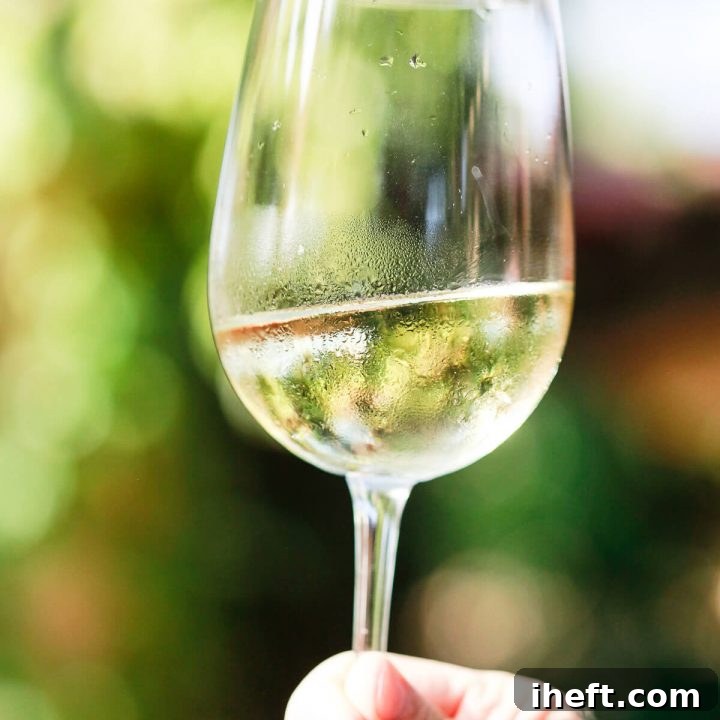 A close-up of a glass of white wine, perfectly chilled and ready to be enjoyed.