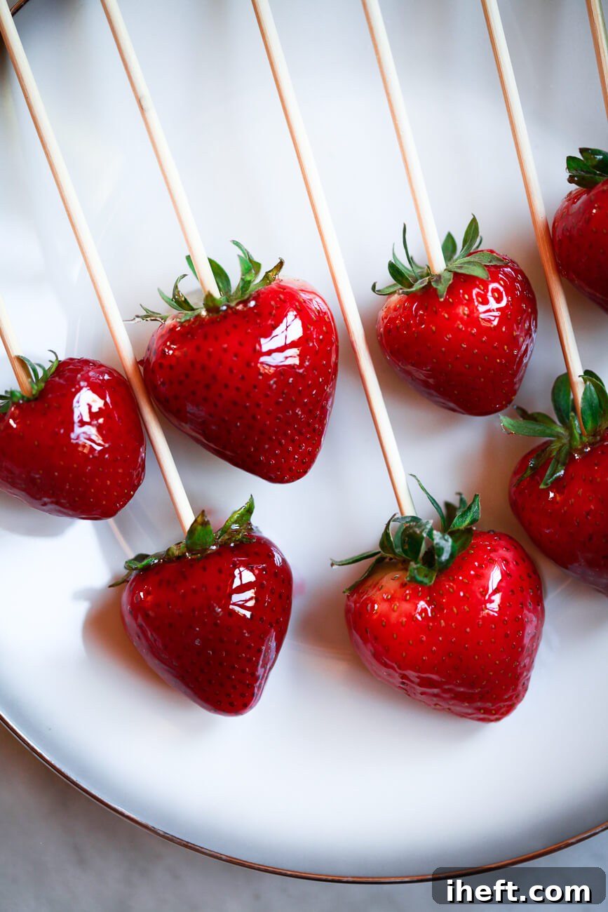 Homemade Tanghulu strawberries on a white plate.