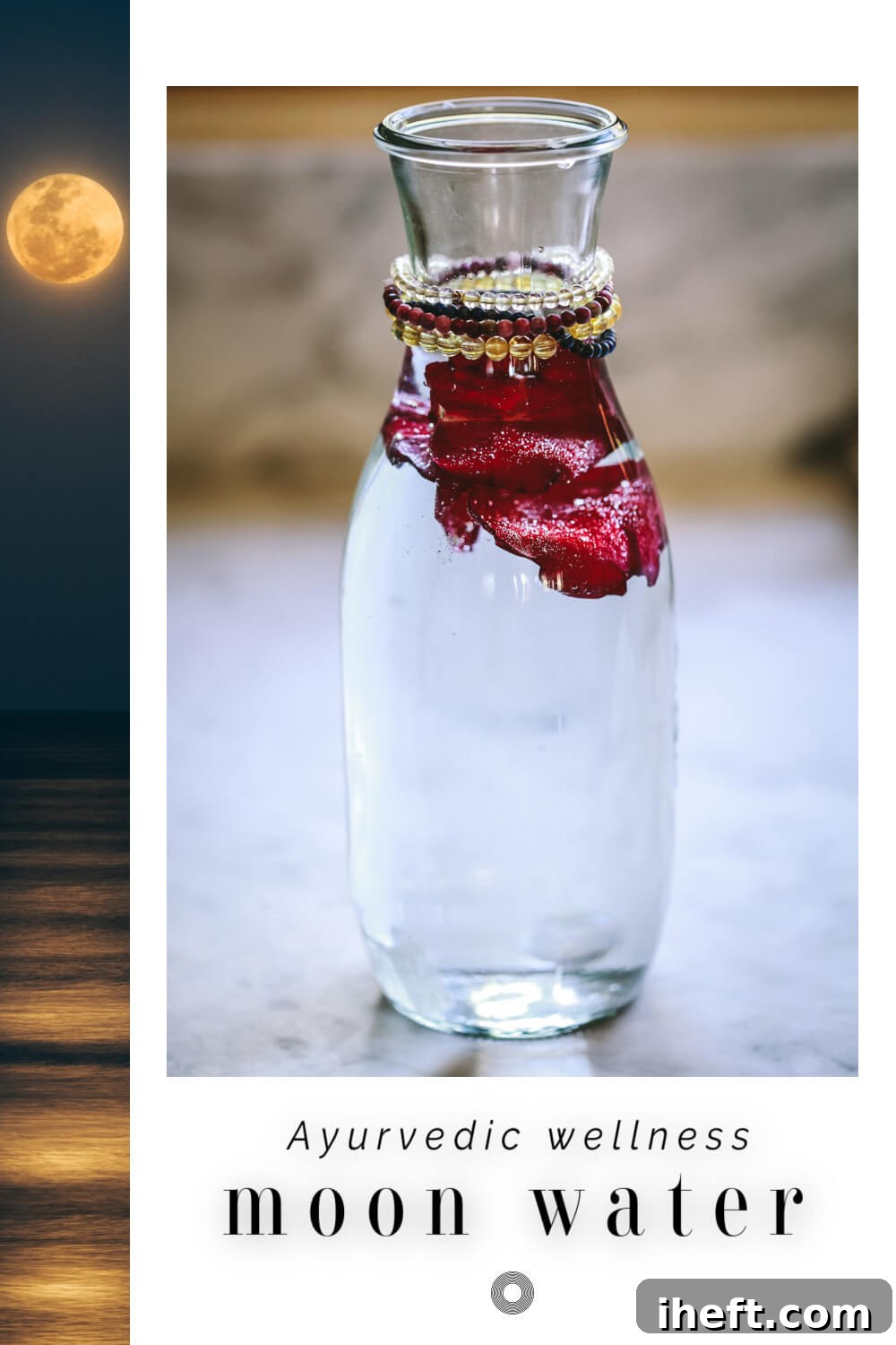 A glass carafe filled with full moon water, rose petals, and crystals.