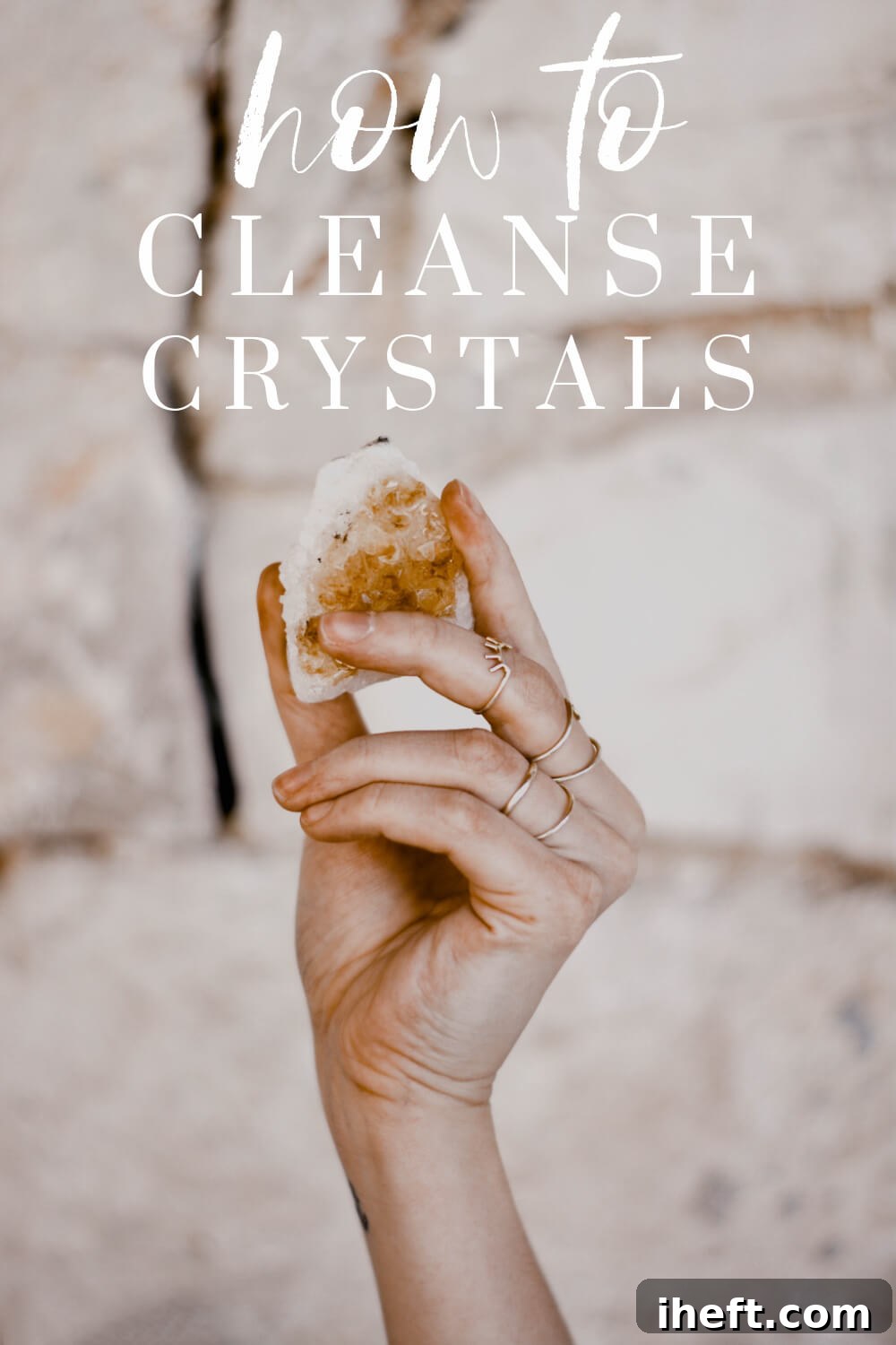 A hand holds up a yellow crystal. White text overlay reads, "how to cleanse crystals"