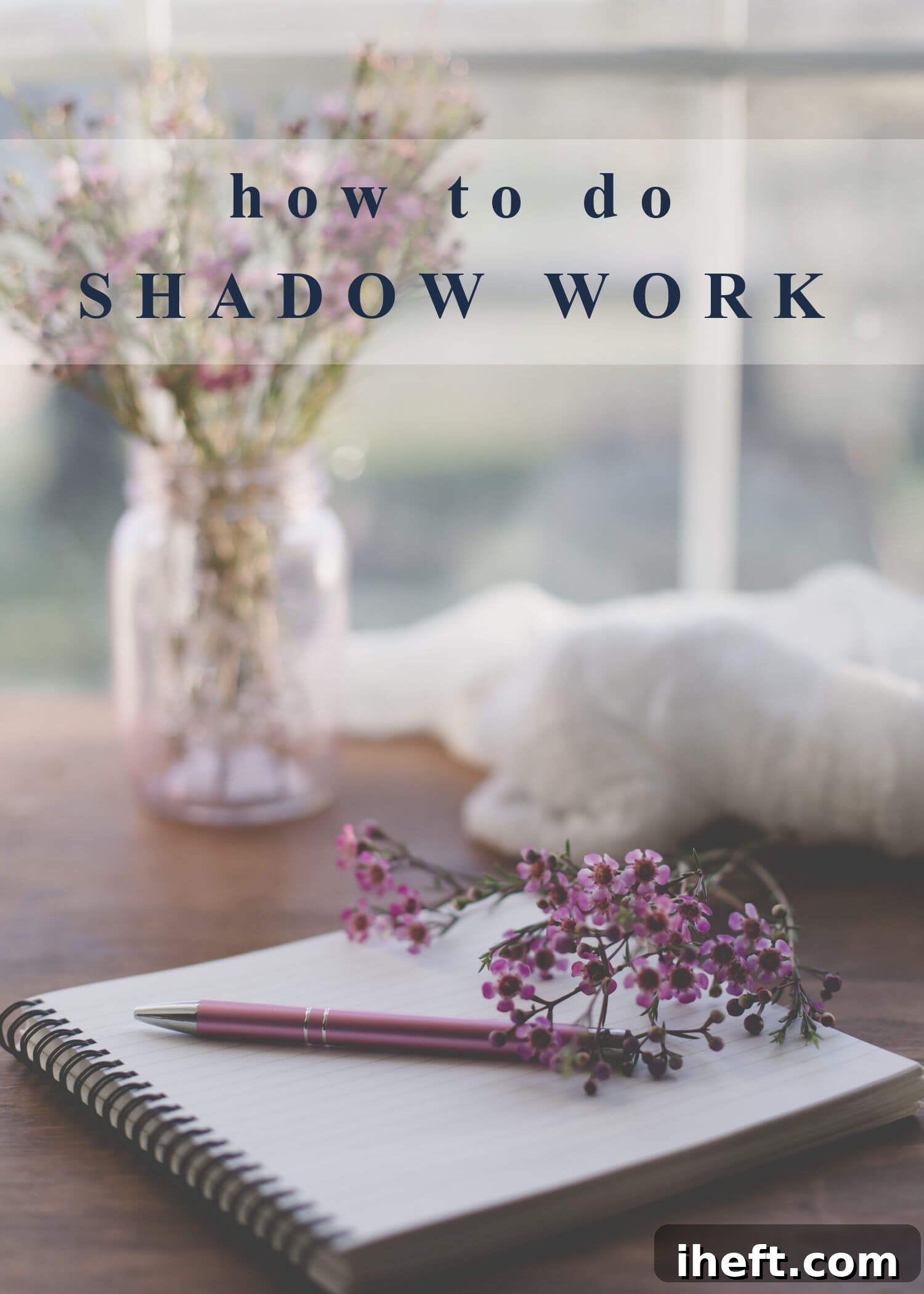 A beautifully styled photo of a journal with a pen, set on a rustic wooden desk, with a jar of purple flowers gently blurred in the background. The text overlay reads, "how to do shadow work," inviting reflection.