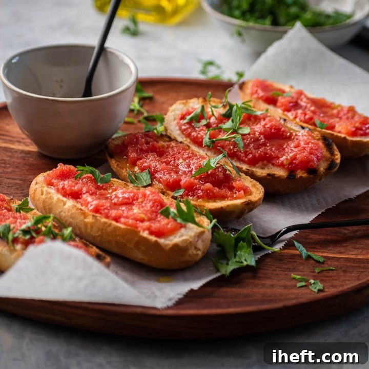 Pan con tomate on a wood cutting board garnished with parsley.