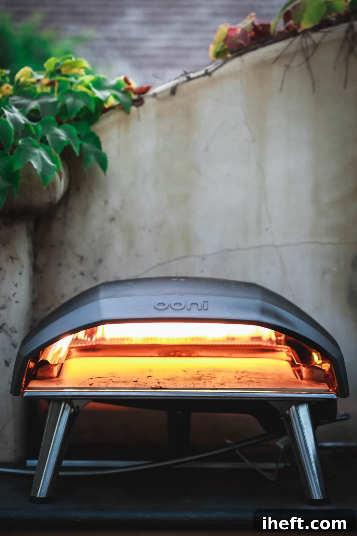An Ooni Koda 16 pizza oven sits on an outdoor kitchen counter, ready for action. 