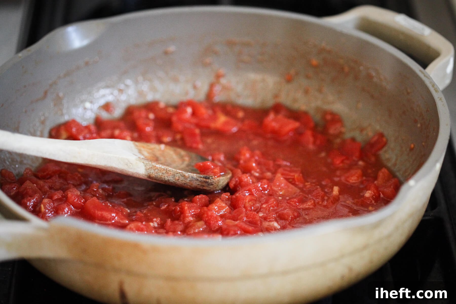 Petite diced tomatoes simmer with herbs and garlic.