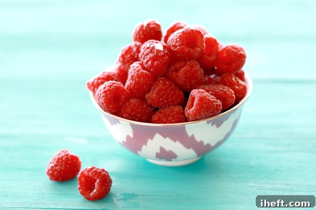 Homemade raspberry glaze with visible fruit pulp in a bowl