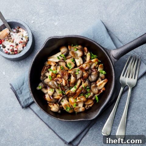 Delicious sautéed mushrooms in a cast iron skillet finished with fresh herbs.