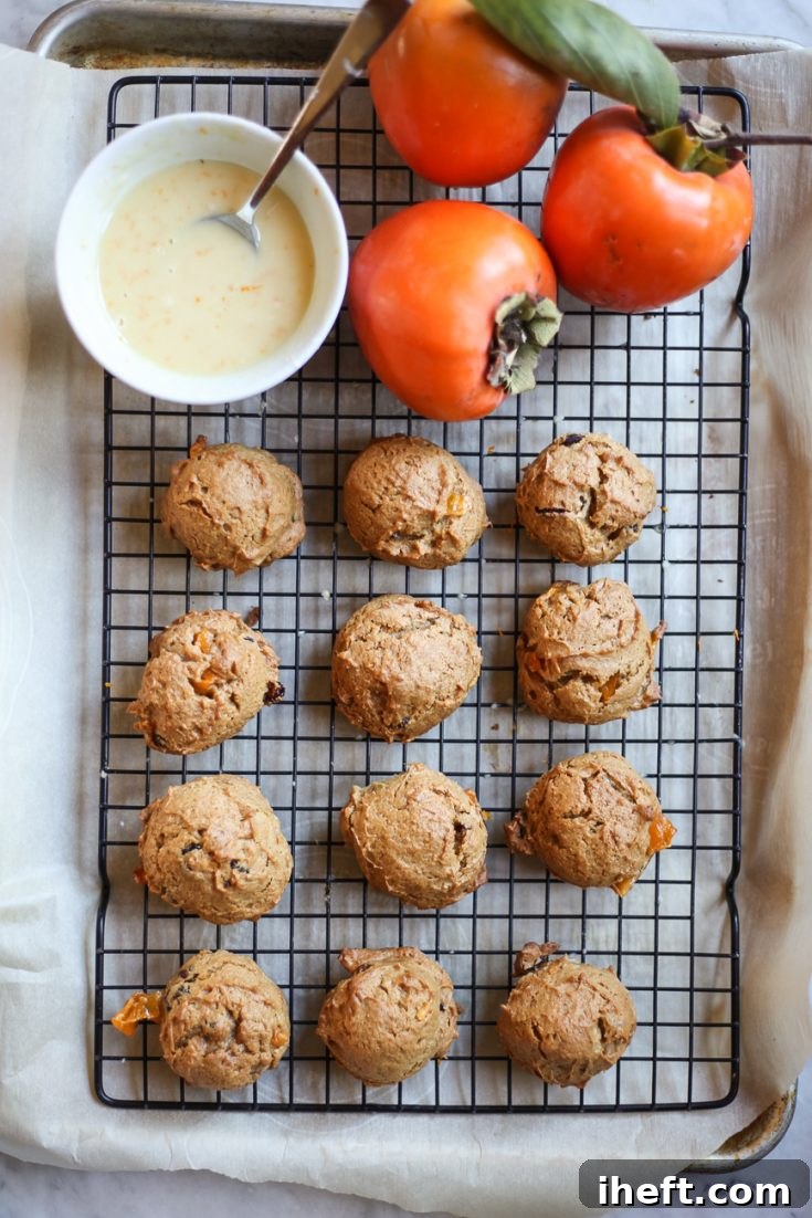 A beautifully composed close-up shot of a stack of freshly baked and glazed persimmon cookies, highlighting their soft texture and inviting appearance, perfect for a festive treat.
