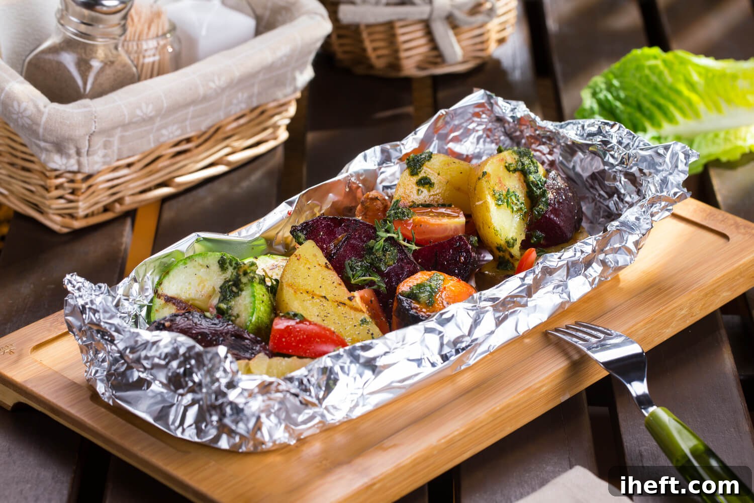 Assorted vegetables perfectly roasted inside a foil packet, ready for serving.