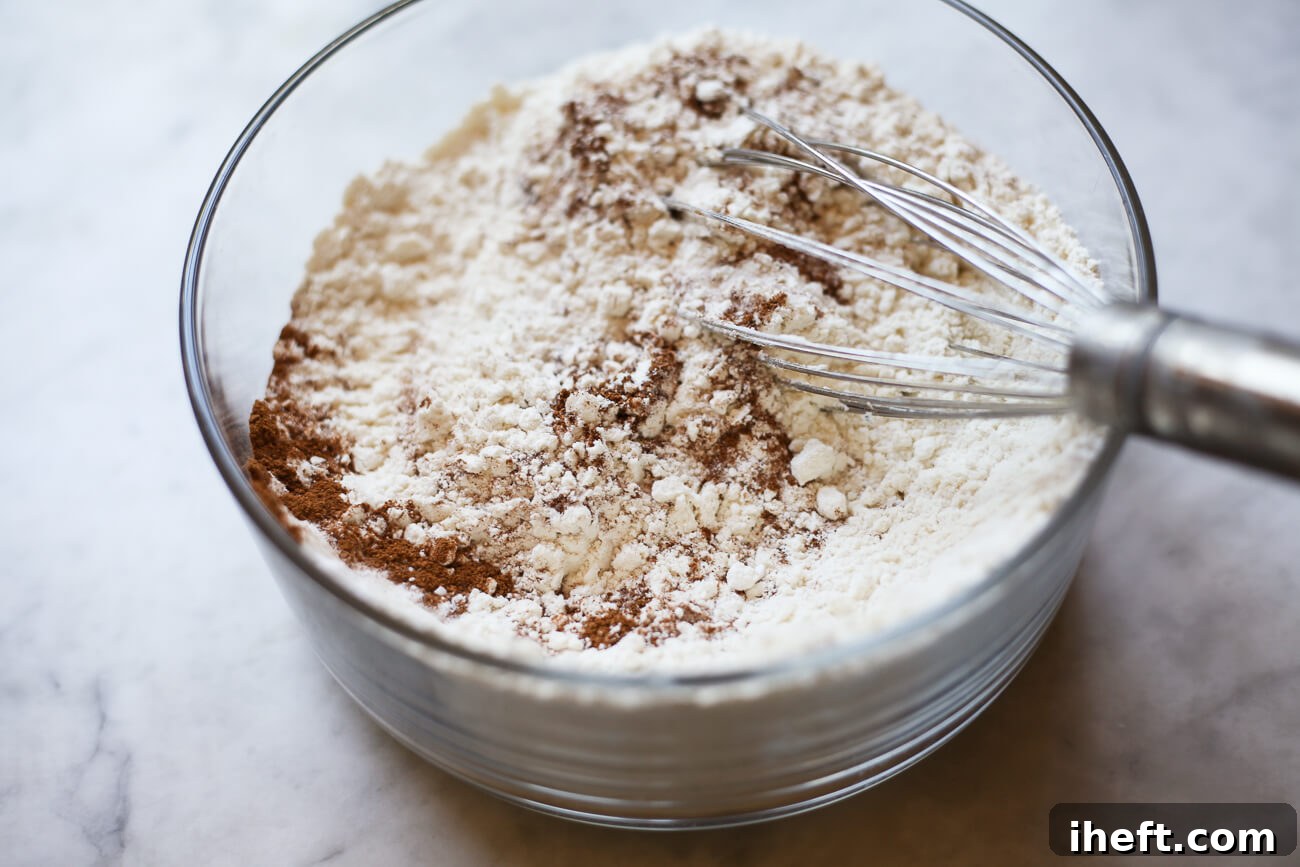 A whisk stirs together dry ingredients for cookies.