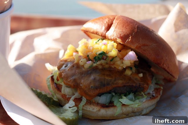 The Maui Burger with grilled pineapple salsa, served with a side of golden French fries at Padaro Beach Grill.