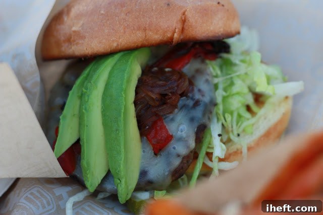The California Burger featuring fresh avocado and other toppings, presented with a side of fries at Padaro Beach Grill.