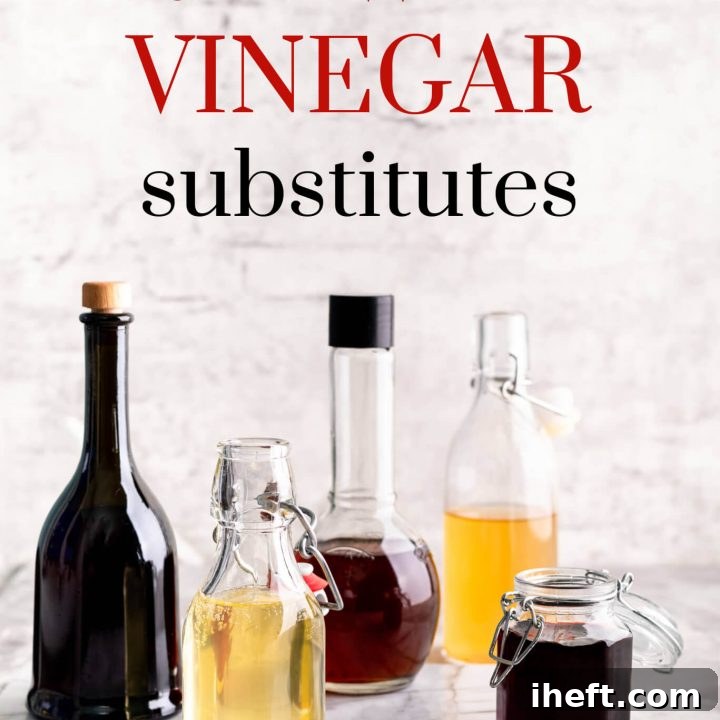 Five glass bottles filled with various vinegars, including red wine vinegar, white wine vinegar, and balsamic vinegar, arranged neatly in a bright white kitchen setting.