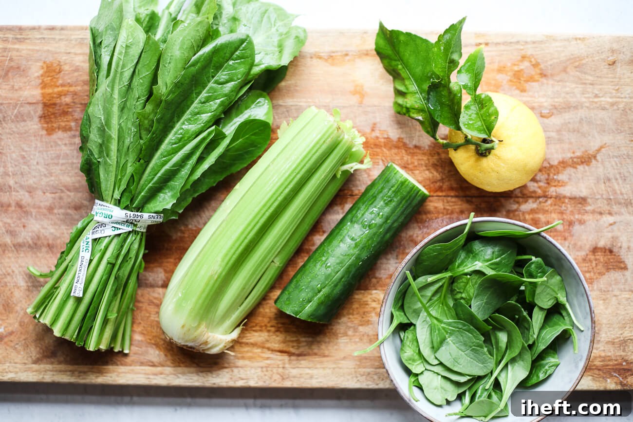 The vibrant ingredients for detox green juice meticulously arranged on a clean cutting board: fresh dandelion greens, crisp celery, hydrating cucumber, a bright lemon, and tender spinach.