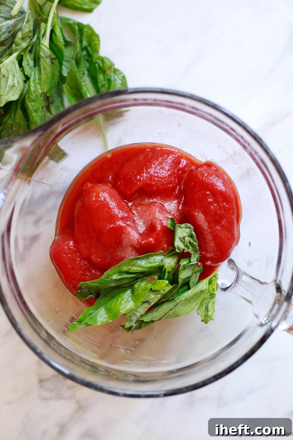 San Marzano canned tomatoes in a bowl with fresh basil.