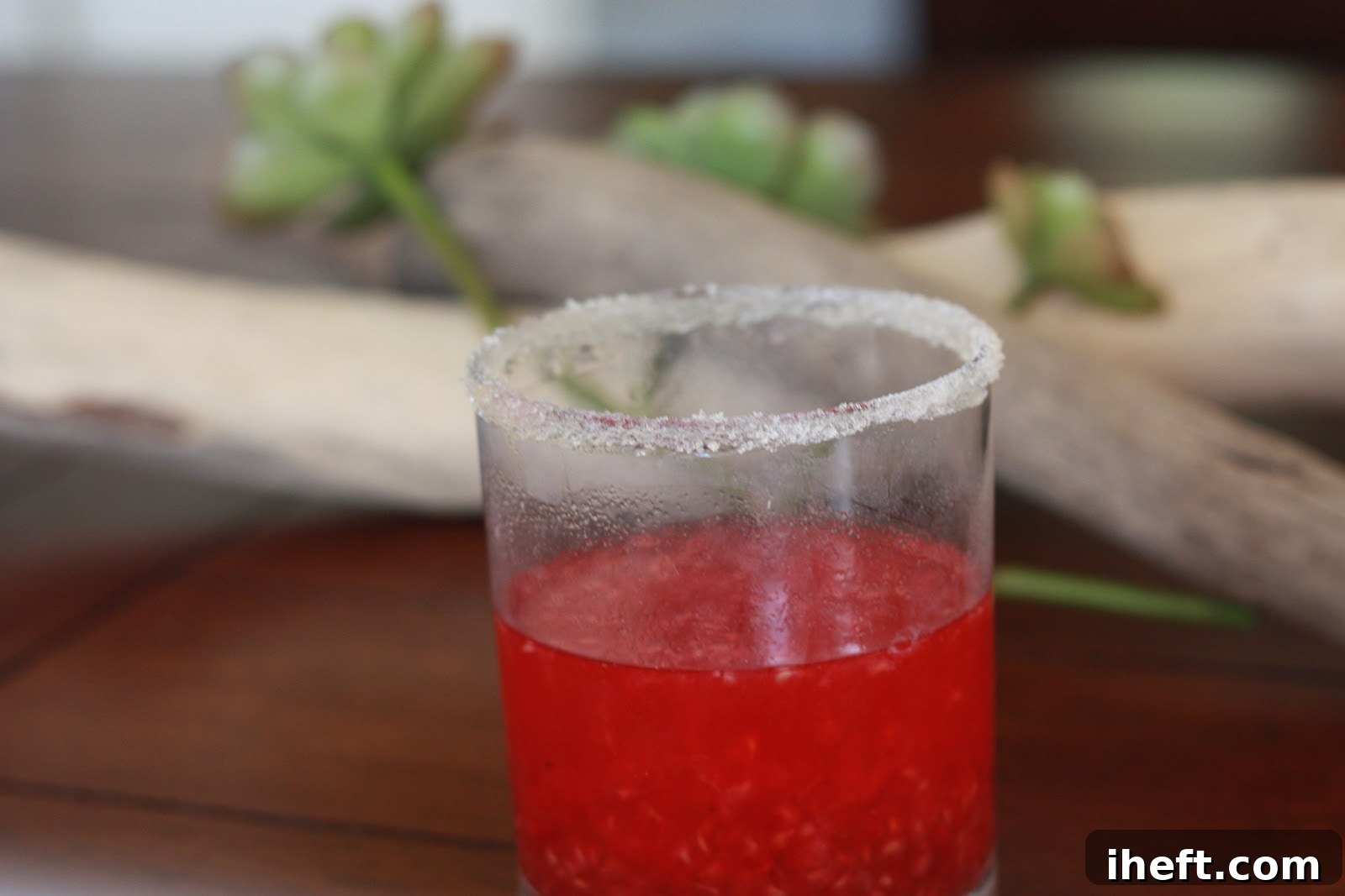 A vibrant Raspberry Smash cocktail, garnished with fresh berries, perfect for a festive adult gathering.