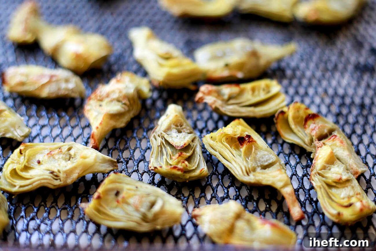 Crispy artichoke hearts on an air fryer tray.
