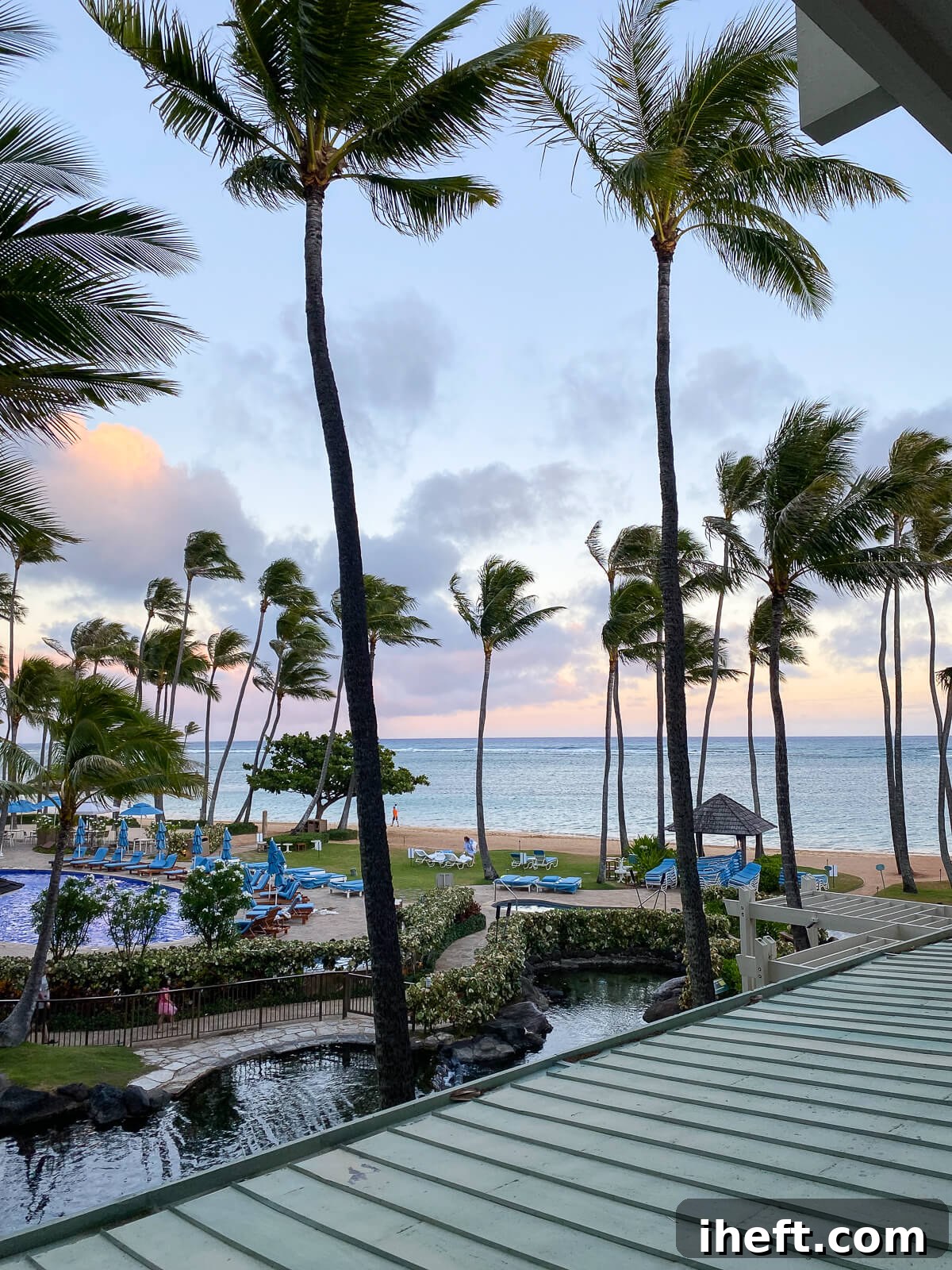 A sunset view looking out over the ocean, pool, and dolphin pool from the Veranda at the Kahala Hotel and Resort in Honolulu. 