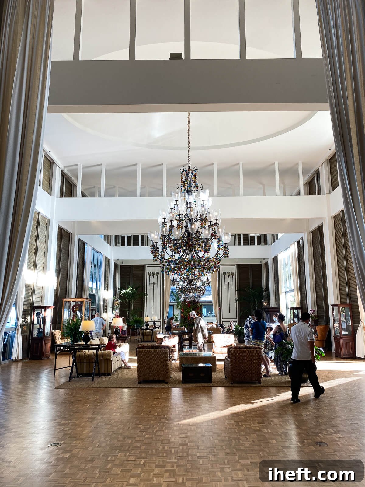 The grand lobby at the Kahala hotel with large chandelier and high ceilings. 