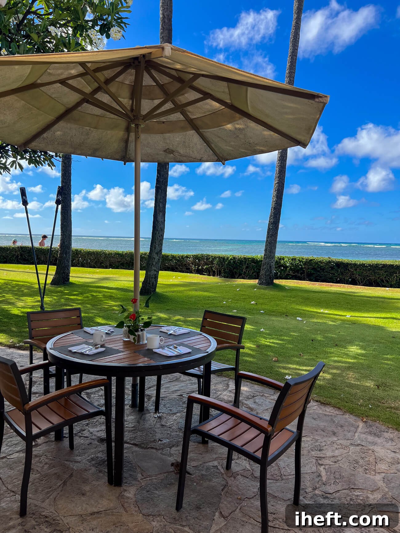 An oceanfront outdoor dining table at the Kahala Resort on Oahu, Hawaii.
