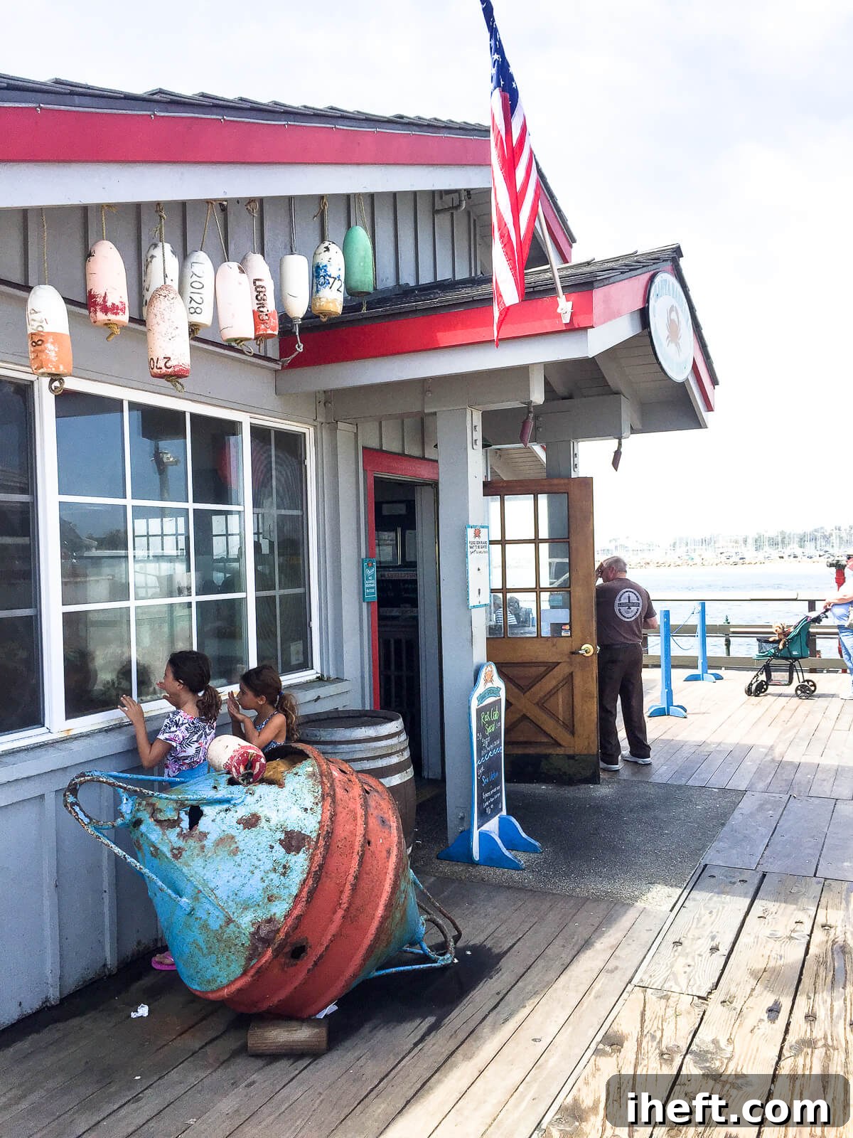 Two little girls peer into a window on Stearn's Wharf in Santa Barbara. A fun thing to do in Santa Barbara with kids. 