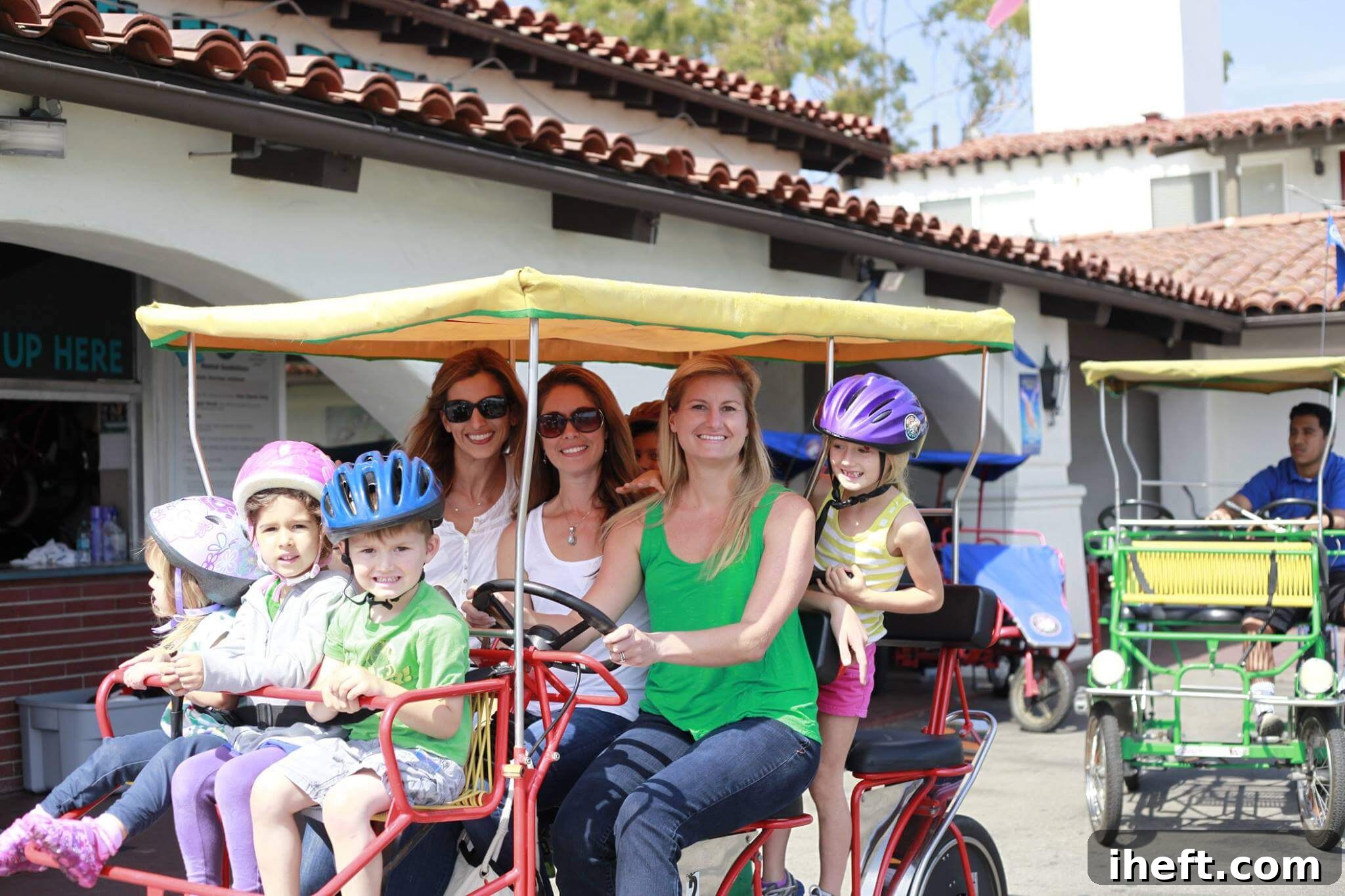 Three moms and a 5 young kids ride in a Surry that was rented at Wheel Fun Rentals in Santa Barbara. 