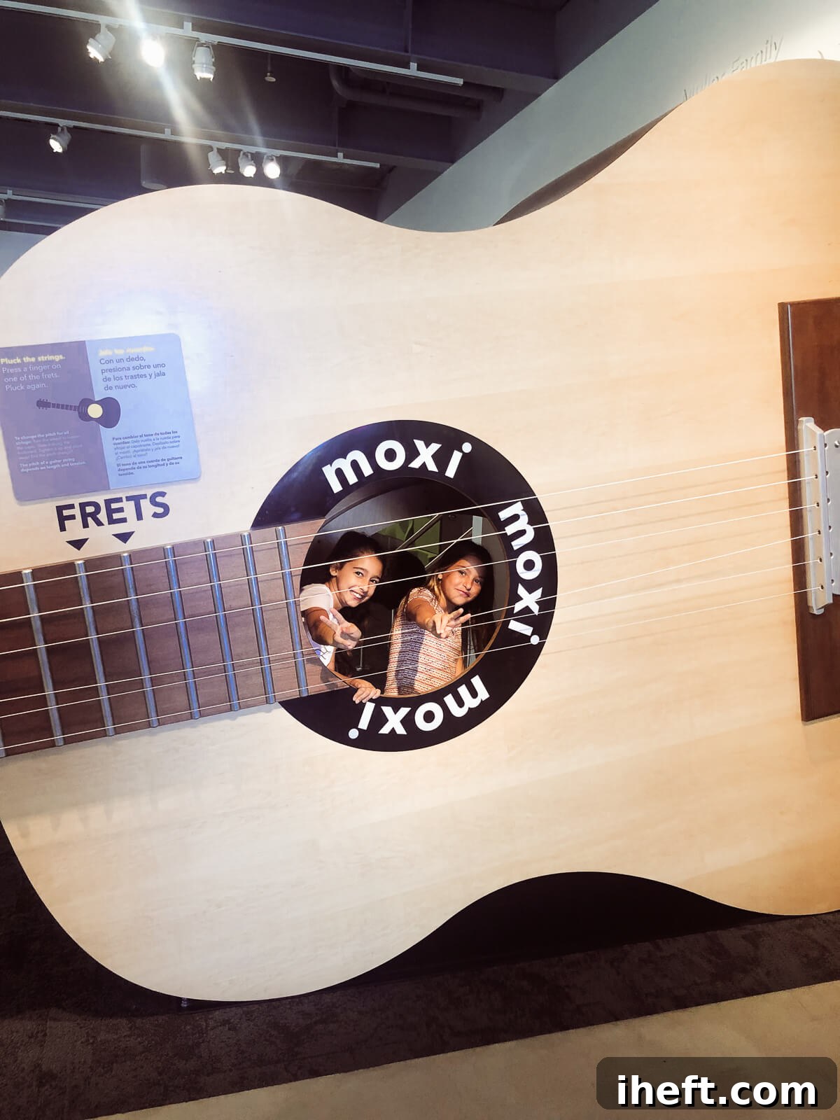 Two young girls play inside a huge model guitar at the MOXI museum in Santa Barbara. 