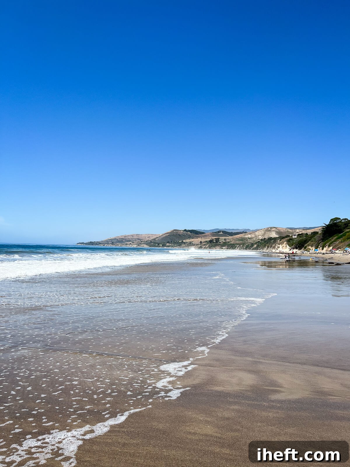 El Capitan Beach, showcasing its pristine beauty with a clear blue sky, sparkling ocean waters, and a wide sandy shore, perfect for a coastal escape.