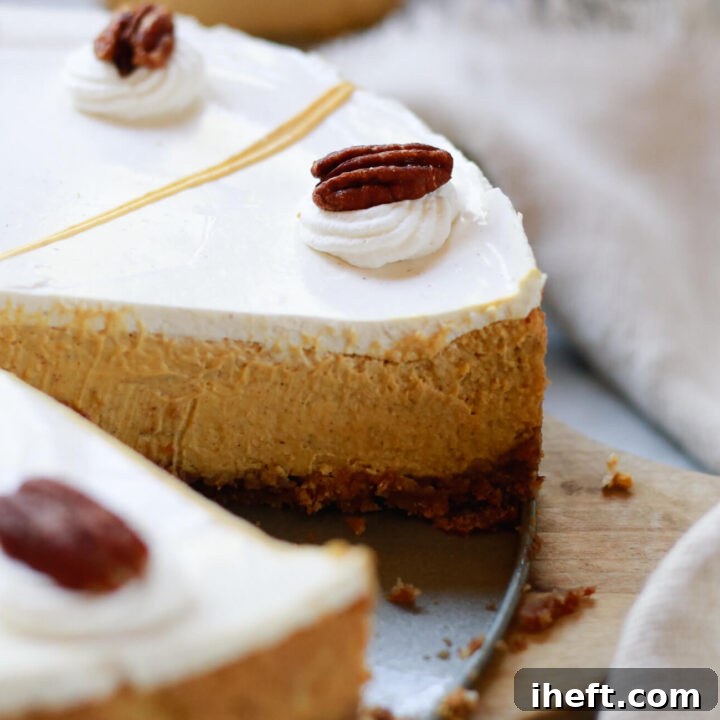 The ultimate homemade Pumpkin Pie Cheesecake with Sour Cream Topping, ready to be served at a festive fall gathering or Thanksgiving dinner.