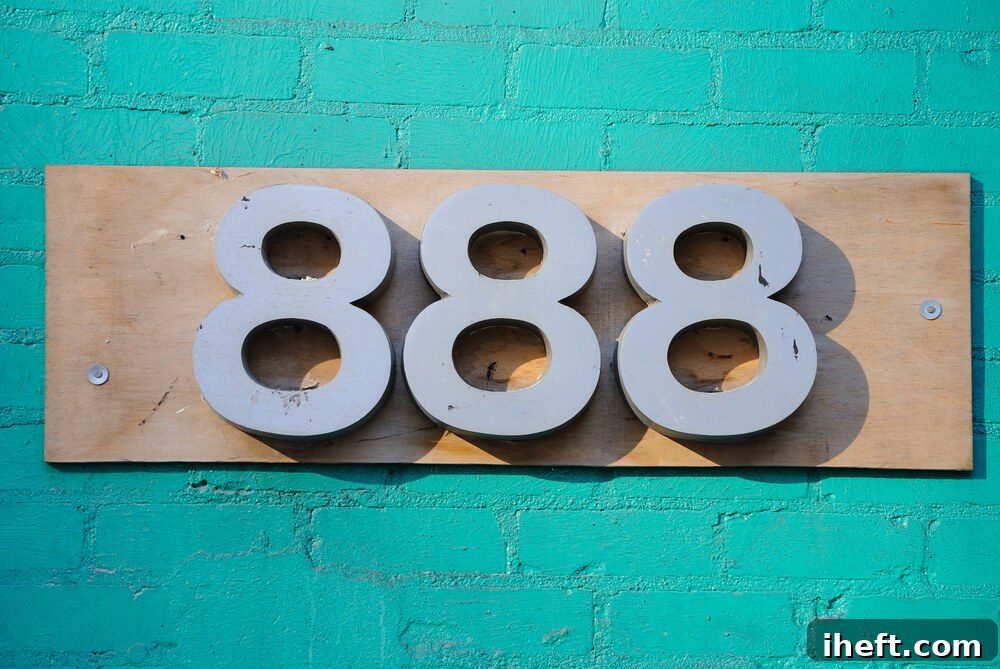 An address 888 on a turquoise brick wall. 