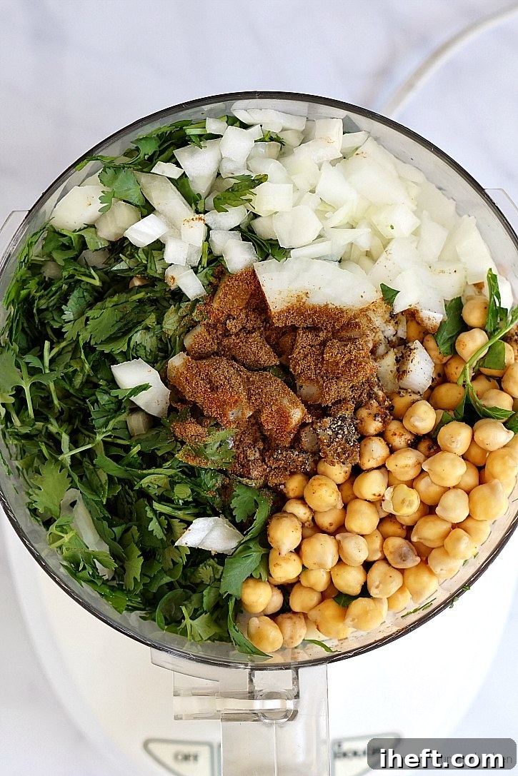 This falafel recipe is easy to make in the food processor with chickpeas, herbs, spices, and onion. 