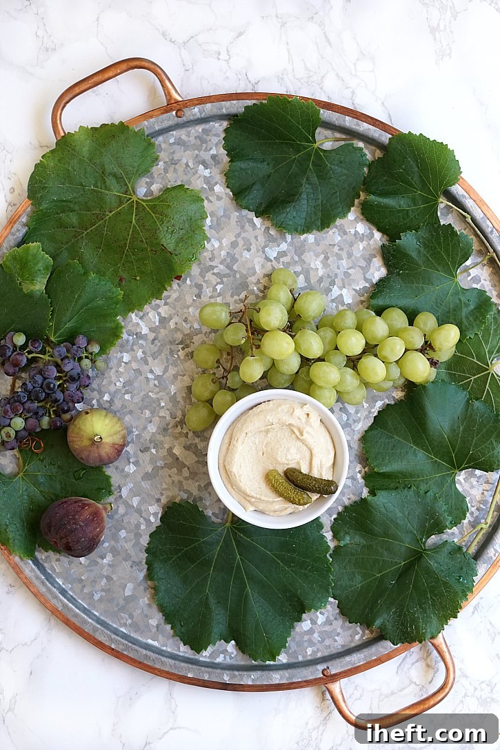 A round Pottery Barn serving tray gets filled with fresh ingredients for a snack platter.