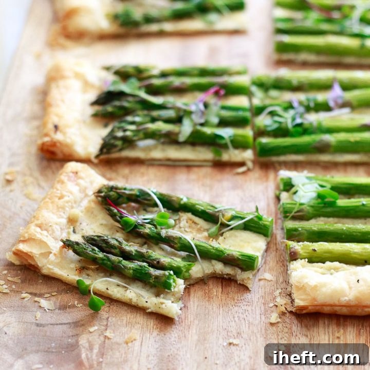 Beautiful square of asparagus tart made with puff pastry, fresh asparagus, and goat cheese.