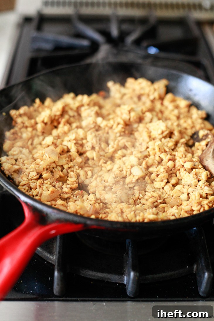 Cooked taco tempeh filling simmering in a skillet, perfectly seasoned and ready to be used for filling delicious tacos.
